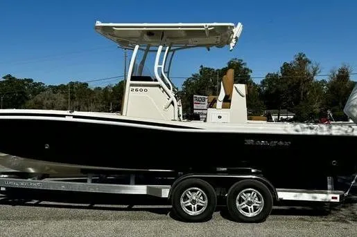 The Image of 2026 Ranger 2600 Bay boat on trailer, side view, outdoors, clear sky. - 0