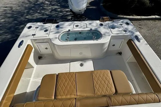 Slide: The Image of 2026 Ranger 2600 Bay boat interior with tan seating and livewell. - 11