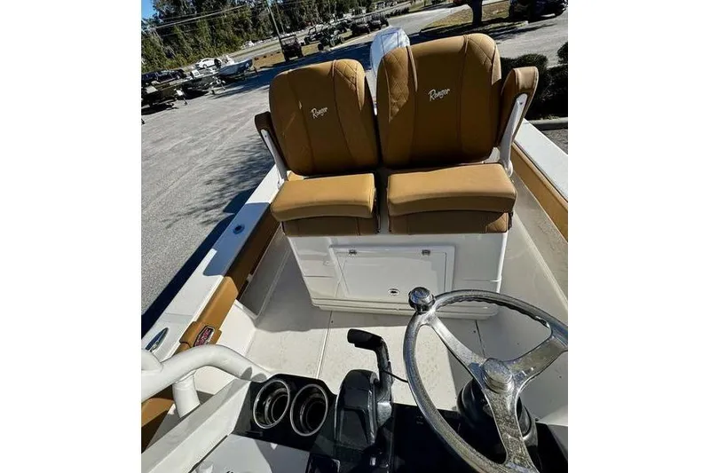 Slide: The Image of 2026 Ranger 2600 Bay boat interior with tan seats and steering wheel. - 12