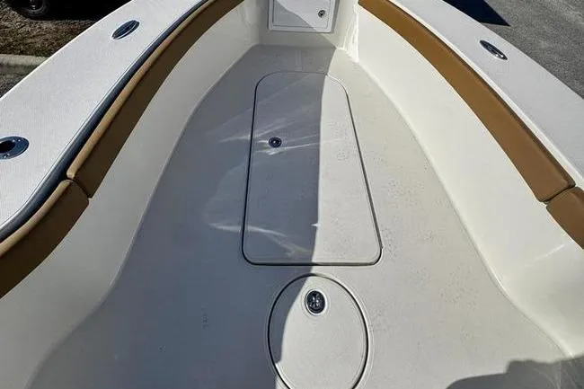 Slide: The Image of 2026 Ranger 2600 Bay boat interior with tan accents and storage compartments. - 9