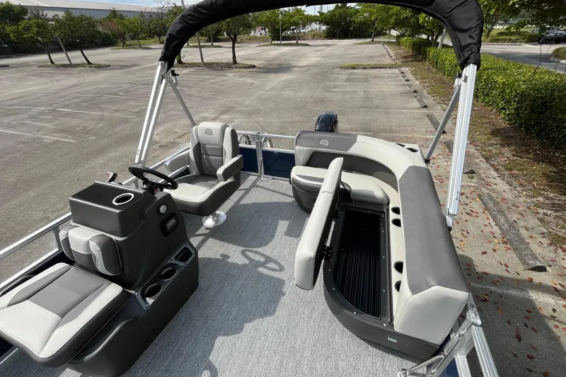Slide: The Image of 2026 Sun Tracker Bass Buggy 16 XL Select pontoon boat interior with seating and steering console. - 11