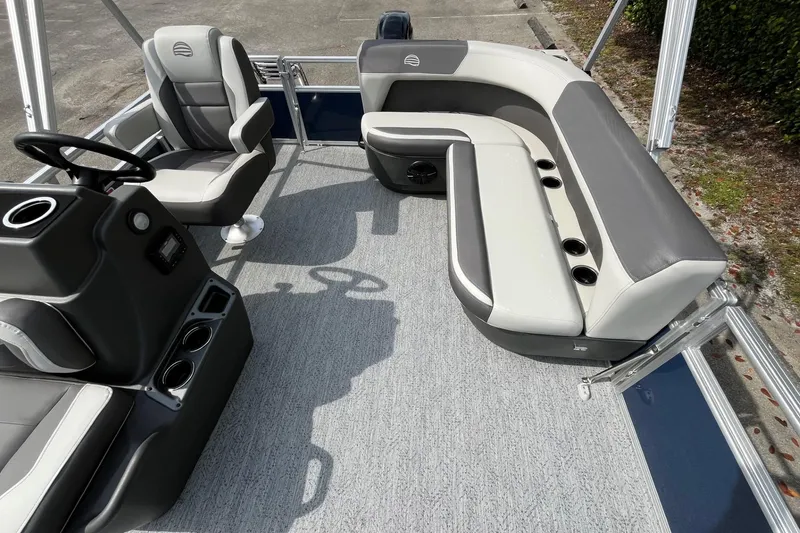 Slide: The Image of 2026 Sun Tracker Bass Buggy 16 XL Select interior with gray seating and steering console. - 12