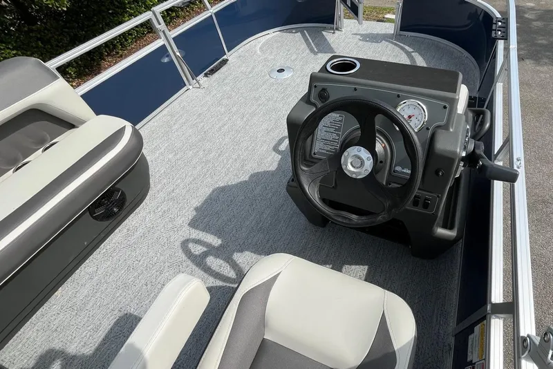 Slide: The Image of 2026 Sun Tracker Bass Buggy 16 XL Select boat interior with steering console and seating. - 8
