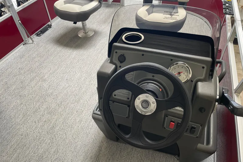 Slide: The Image of 2026 Sun Tracker Bass Buggy 16 XL Select steering console with modern controls and seating. - 9