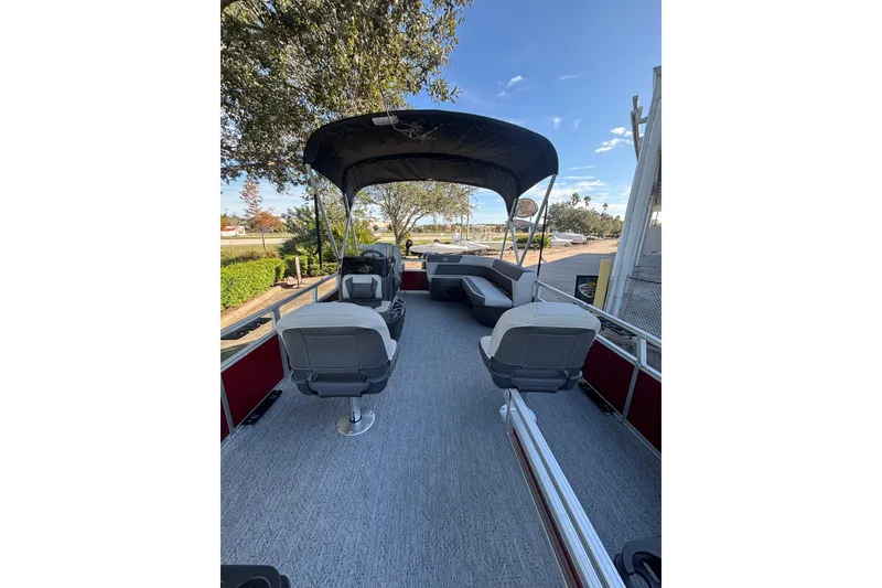 Slide: The Image of 2026 Sun Tracker Bass Buggy 16 XL Select pontoon boat with canopy and seating. - 3