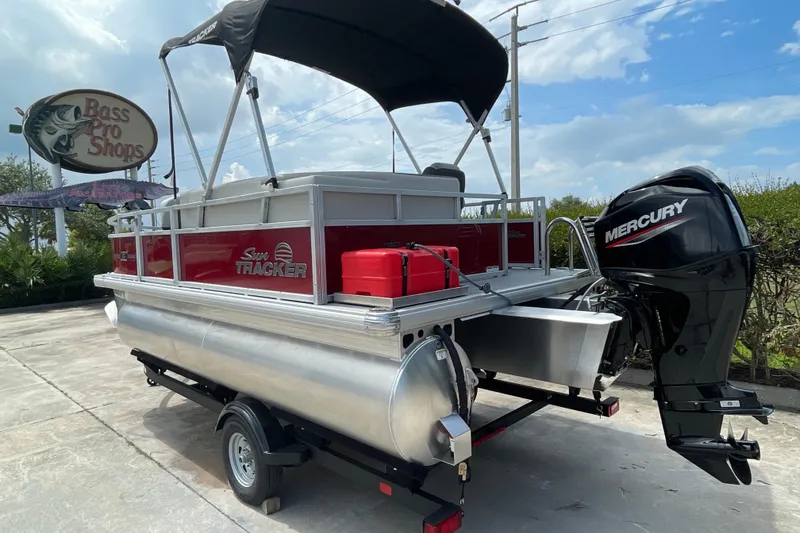 Slide: The Image of 2026 Sun Tracker Bass Buggy 16 XL Select pontoon boat with Mercury engine at Bass Pro Shops. - 2