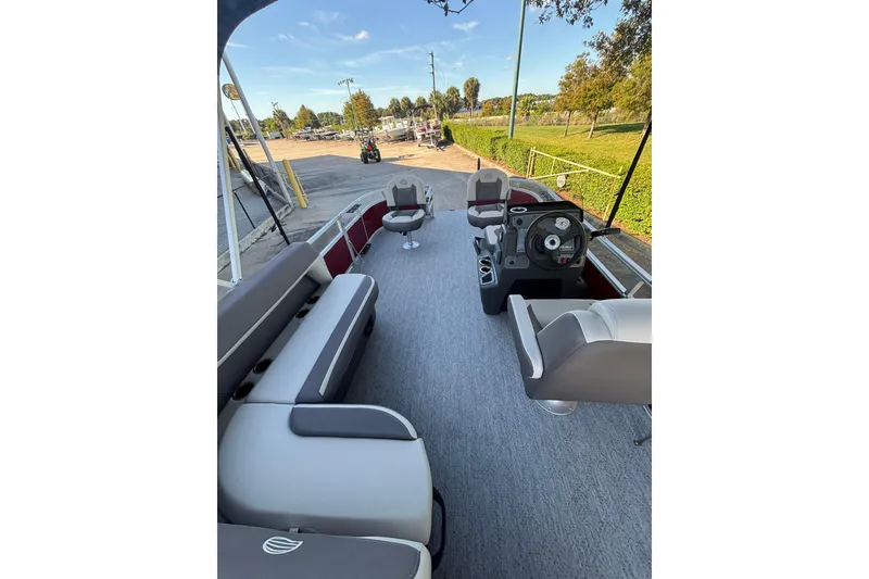 Slide: The Image of 2026 Sun Tracker Bass Buggy 16 XL Select pontoon boat interior with seating and steering console. - 5