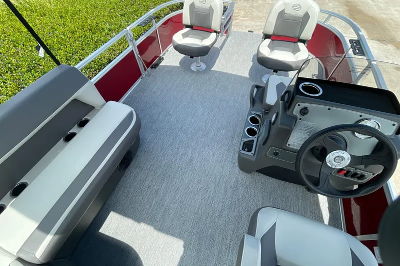 Slide: The Image of 2026 Sun Tracker Bass Buggy 16 XL Select pontoon boat interior with seating and steering console. - 7