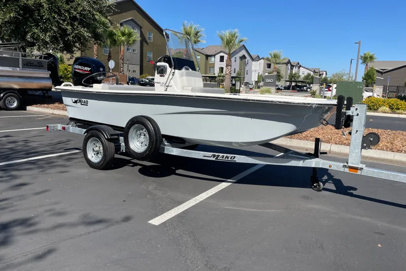 Slide: The Image of 2026 Mako Pro Skiff 13 CC boat on trailer in parking lot. - 2