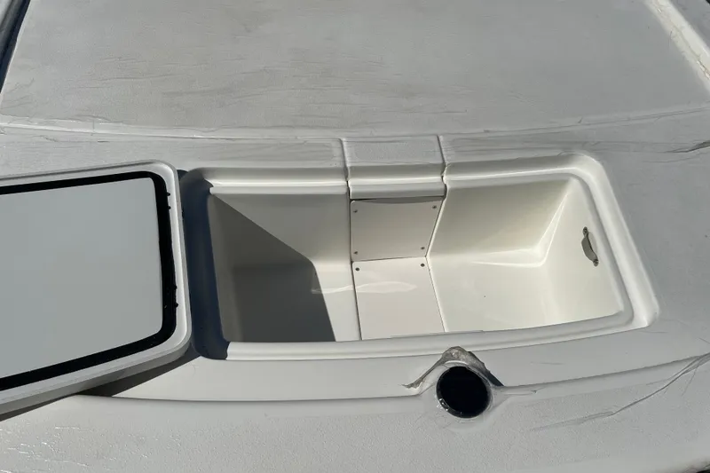 Slide: The Image of Open storage compartment on a 2026 Mako Pro Skiff 13 CC boat. - 5