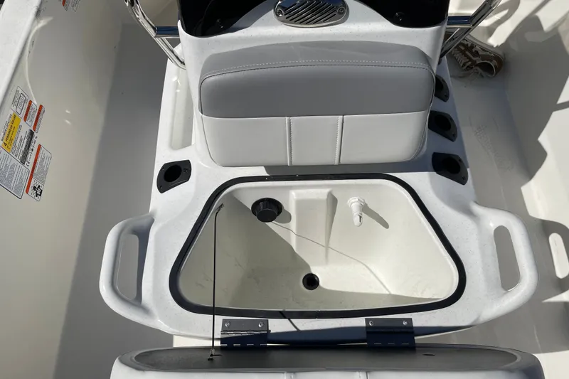 Slide: The Image of 2026 Mako Pro Skiff 13 CC boat interior with storage compartment and seating. - 9