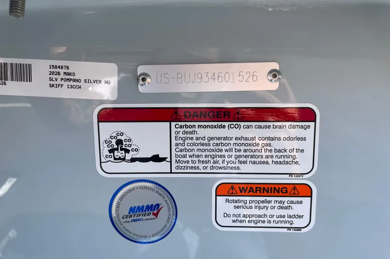 Slide: The Image of 2026 Mako Pro Skiff 13 CC warning labels for carbon monoxide and propeller safety. - 53