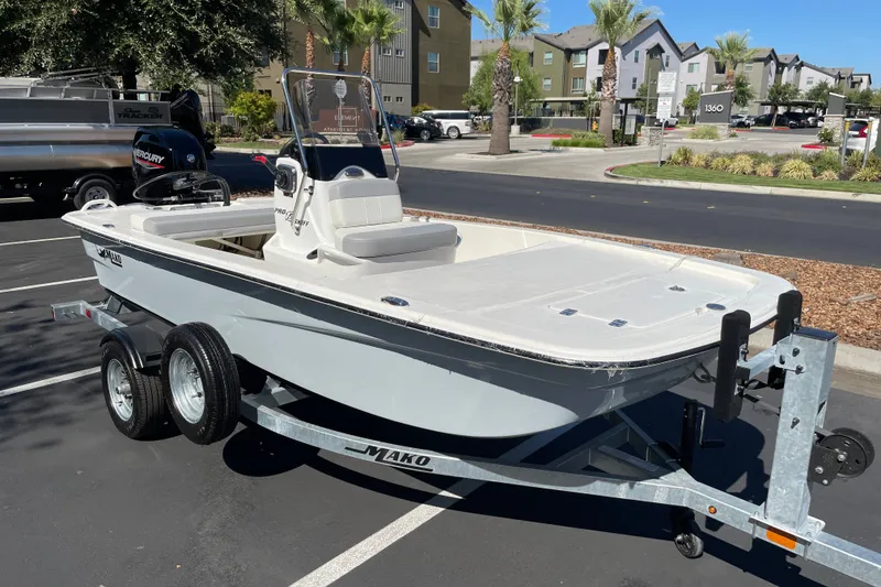 Slide: The Image of 2026 Mako Pro Skiff 13 CC boat on trailer in parking lot. - 1