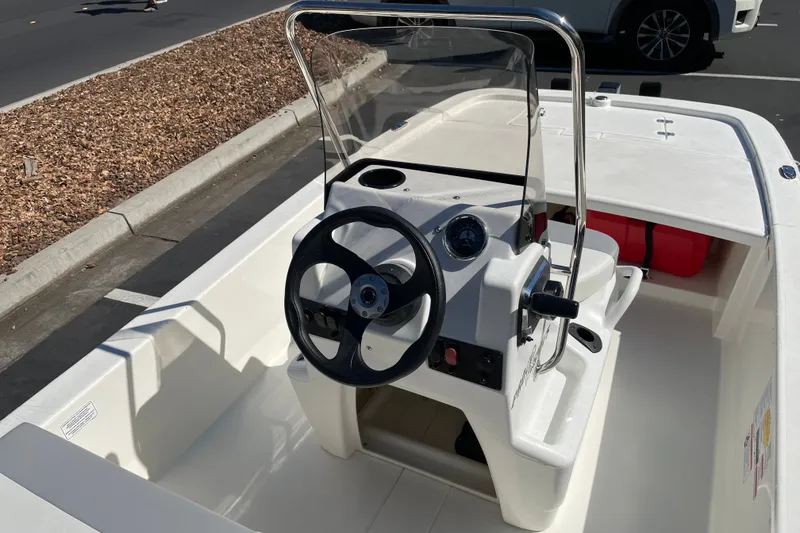 Slide: The Image of 2026 Mako Pro Skiff 13 CC boat interior with steering console and seating. - 7