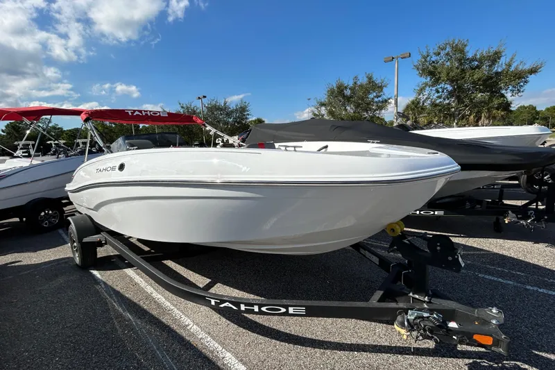 The Image of 2026 Tahoe T18 boat on trailer, parked outdoors under blue sky. - 0