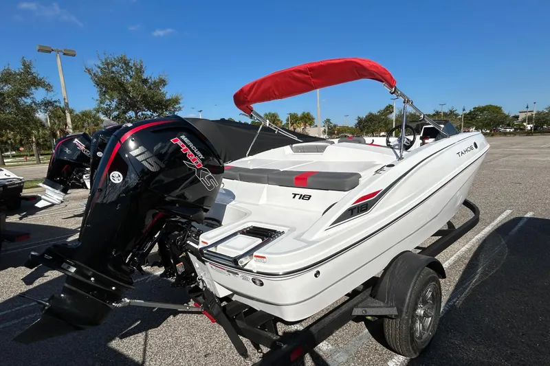 Slide: The Image of 2026 Tahoe T18 boat with red canopy and Mercury Pro XS engine on trailer. - 1