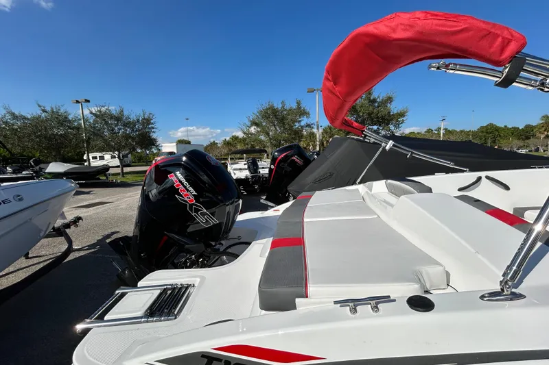 Slide: The Image of 2026 Tahoe T18 boat with Mercury Pro XS engines, parked outdoors under a clear blue sky. - 2