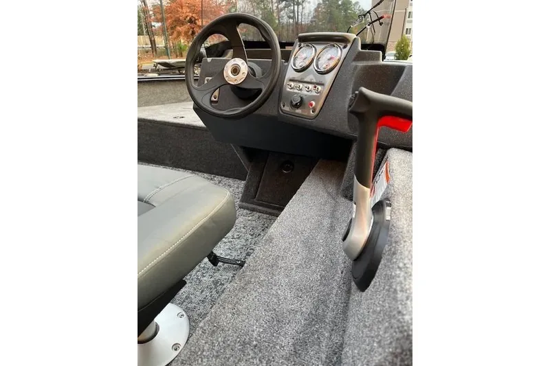 Slide: The Image of 2026 Tracker Pro Guide V-16 SC boat interior with steering wheel and control panel. - 47