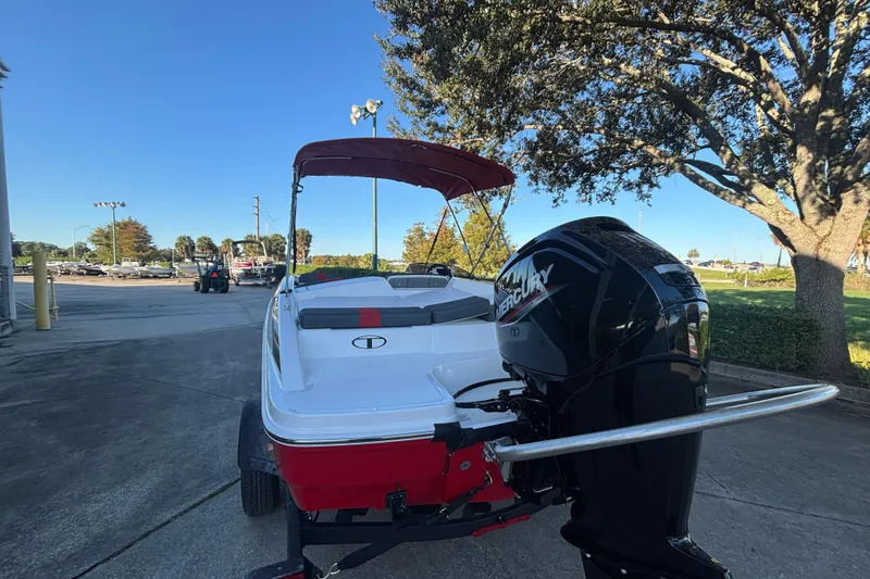 Slide: The Image of 2026 Tahoe T18 boat with Mercury engine, parked outdoors under a clear blue sky. - 3