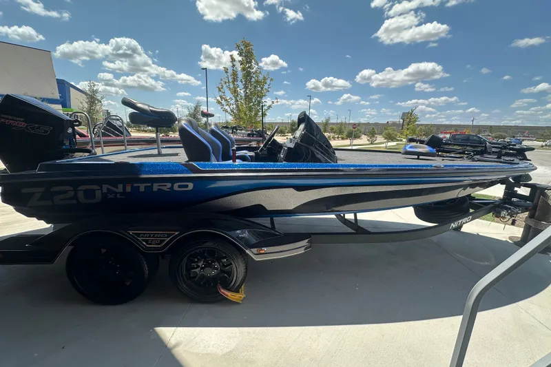 Slide: The Image of 2026 Nitro Z20 XL Pro boat, sleek design, parked outdoors under a blue sky. - 3