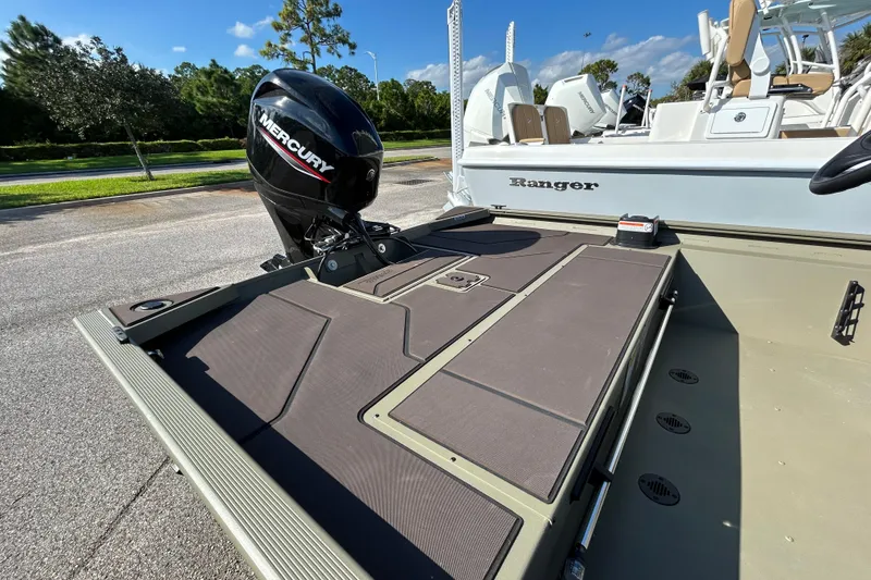 Slide: The Image of 2026 Tracker Grizzly 1860 CC boat with Mercury engine, parked outdoors. - 6