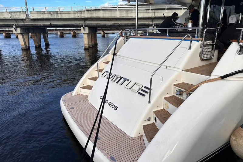 Slide: The Image of 1999 Azimut 85 Ultimate yacht docked near a bridge, rear view. - 101