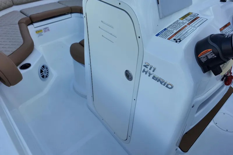 Slide: The Image of 2025 NauticStar 211 Hybrid boat interior with seating and control panel. - 16