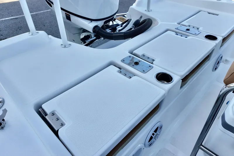 Slide: The Image of 2025 NauticStar 211 Hybrid boat deck with storage compartments and cup holders. - 19