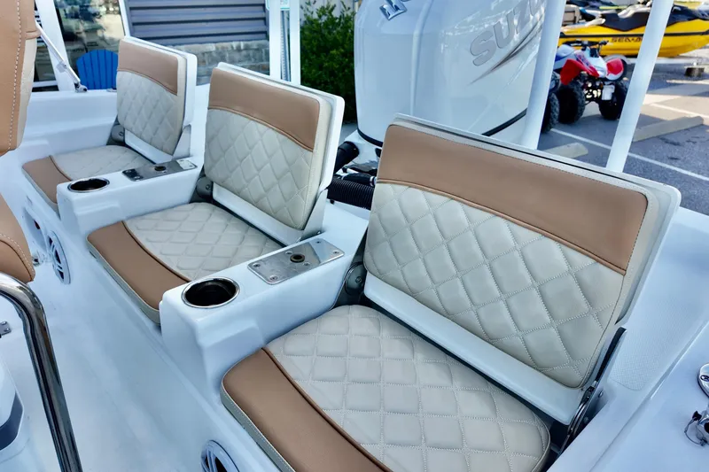 Slide: The Image of 2025 NauticStar 211 Hybrid boat seats with quilted upholstery and cup holders. - 20