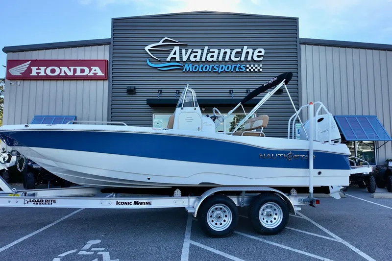 The Image of 2025 NauticStar 211 Hybrid boat on trailer at Avalanche Motorsports dealership. - 4
