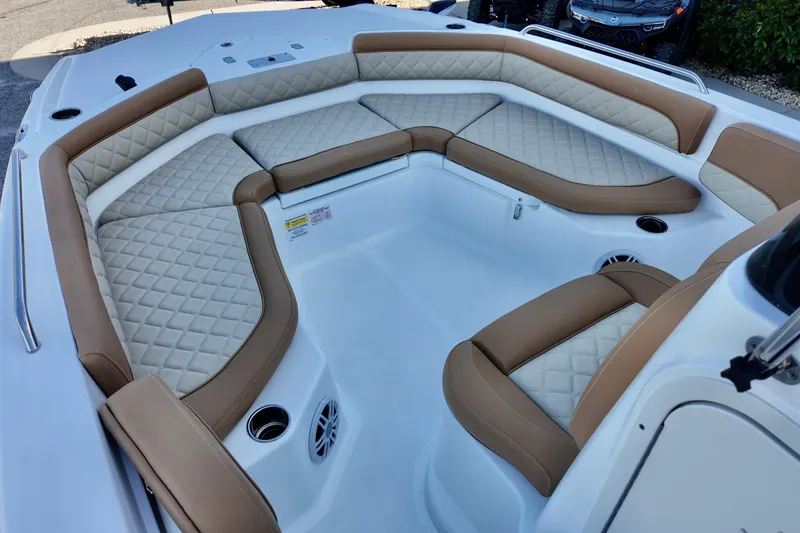Slide: The Image of 2025 NauticStar 211 Hybrid boat interior with luxurious tan and white seating. - 8