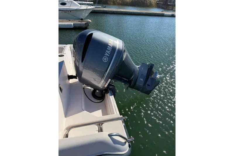 Slide: The Image of Outboard motor on 1998 Grady-White Advance 247 boat, docked in sunny marina. - 11