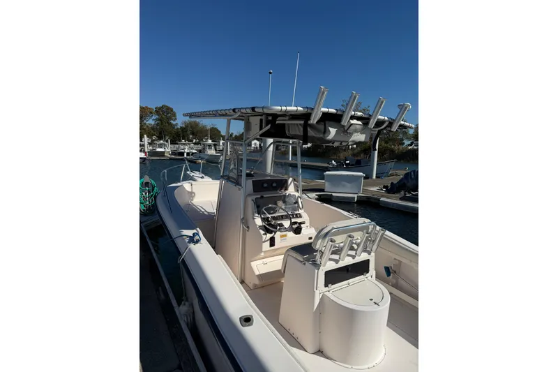 Slide: The Image of 1998 Grady-White Advance 247 boat docked at marina under clear blue sky. - 9