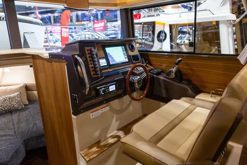Slide: The Image of Manufacturer Provided Image: 2022 Ranger Tugs R-27 helm station with navigation system and wooden steering wheel. - 12