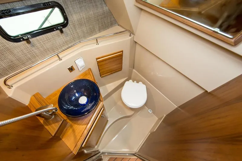 Slide: The Image of Manufacturer Provided Image: 2022 Ranger Tugs R-27 boat bathroom with modern sink and toilet. - 19