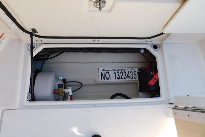 Slide: The Image of 2022 Ranger Tugs R-27 storage compartment with USCG documentation number visible. - 21