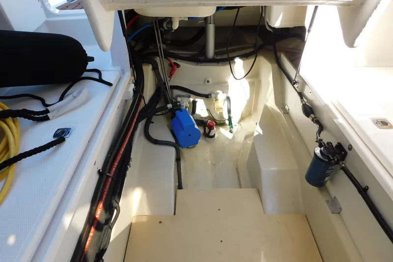 Slide: The Image of Engine compartment of 2022 Ranger Tugs R-27 boat, showcasing wiring and components. - 23