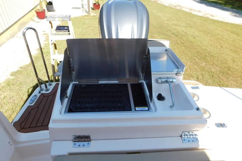 Slide: The Image of Outdoor kitchen setup on 2022 Ranger Tugs R-27 boat with grill and sink. - 26