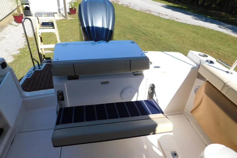 Slide: The Image of 2022 Ranger Tugs R-27 boat interior with seating and outboard motor. - 27