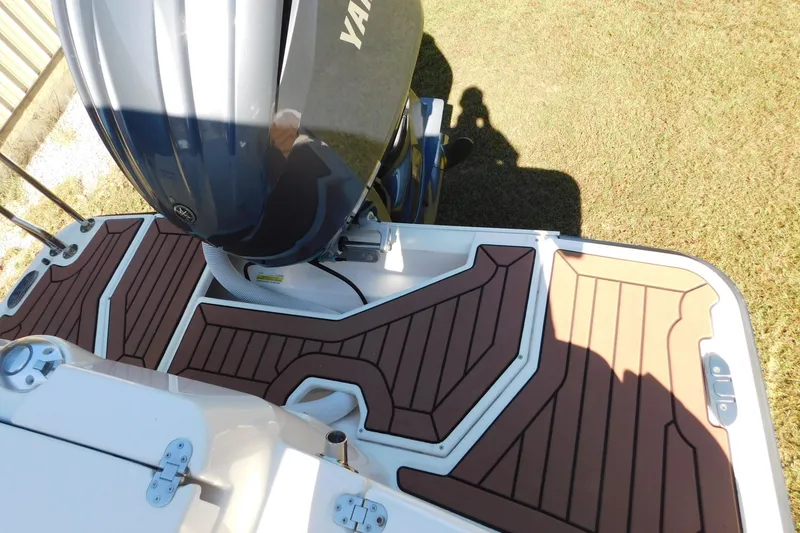 Slide: The Image of 2022 Ranger Tugs R-27 boat with Yamaha engine and teak-style deck flooring. - 28
