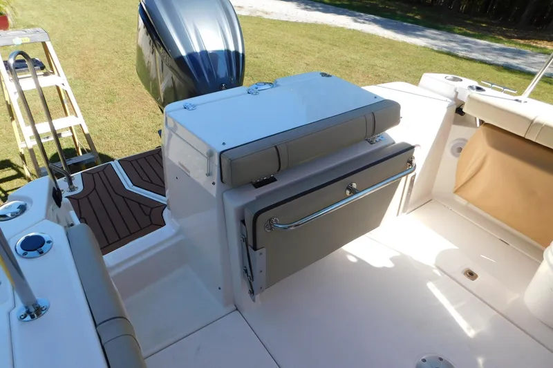 Slide: The Image of 2022 Ranger Tugs R-27 boat interior with seating and outboard motor. - 29