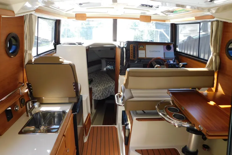 Slide: The Image of Interior of 2022 Ranger Tugs R-27 boat with modern amenities and wood finish. - 33