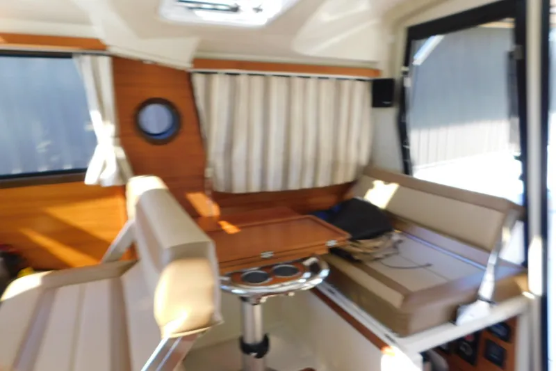 Slide: The Image of Interior of 2022 Ranger Tugs R-27 boat with seating and table. - 36