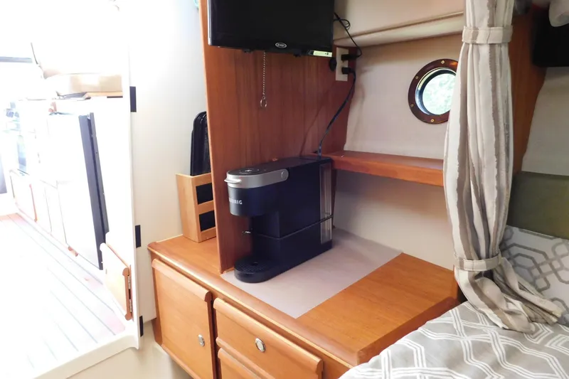 Slide: The Image of Interior of 2022 Ranger Tugs R-27 with coffee maker and porthole window. - 37