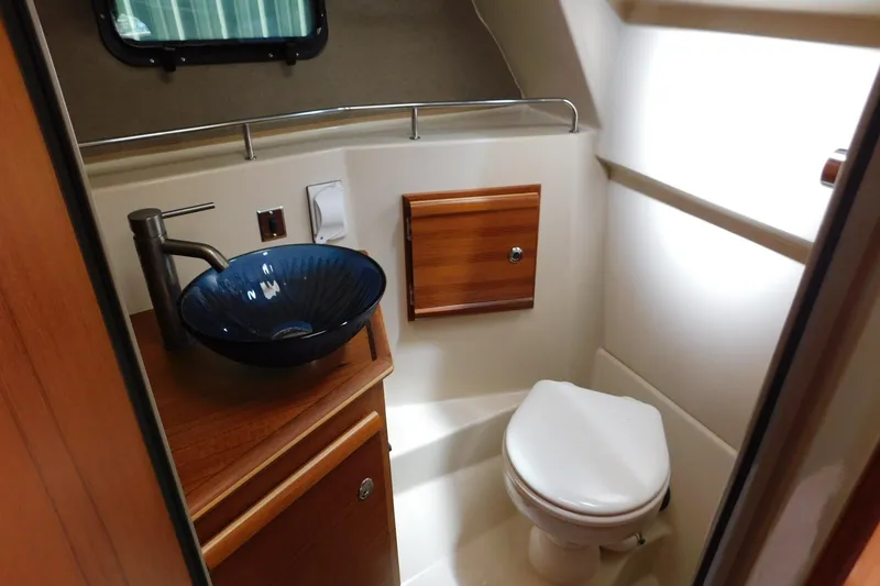 Slide: The Image of 2022 Ranger Tugs R-27 boat bathroom with modern sink and toilet. - 38
