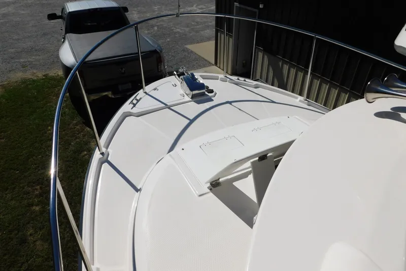 Slide: The Image of 2022 Ranger Tugs R-27 boat deck with railing, parked near a truck. - 45