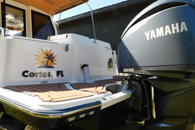 Slide: The Image of 2022 Ranger Tugs R-27 boat with Yamaha engine, Cortes, FL branding. - 57