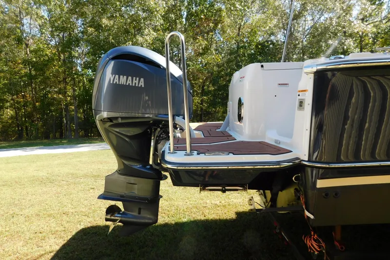 Slide: The Image of 2022 Ranger Tugs R-27 with Yamaha outboard motor, docked on grassy area. - 58