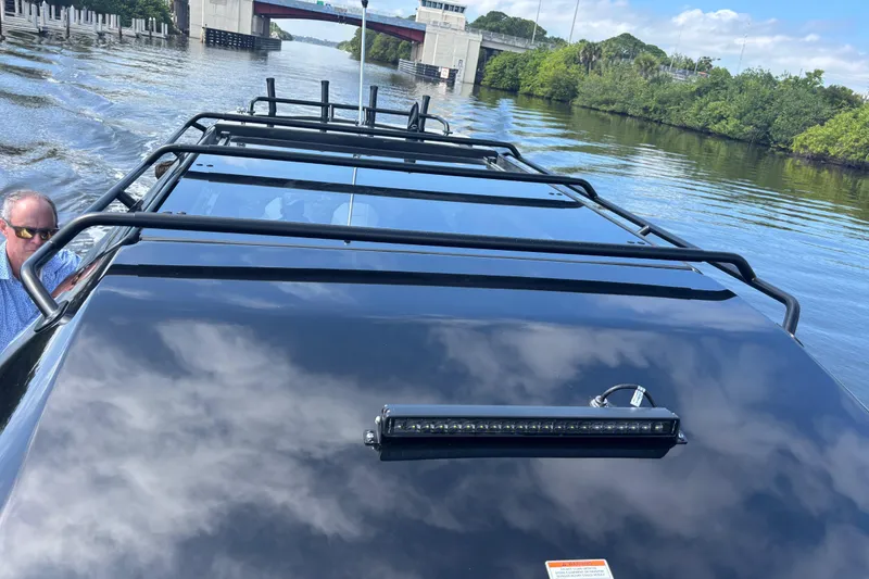 Slide: The Image of Navan C30 2026 vehicle on water, showcasing roof design and scenic background. - 10