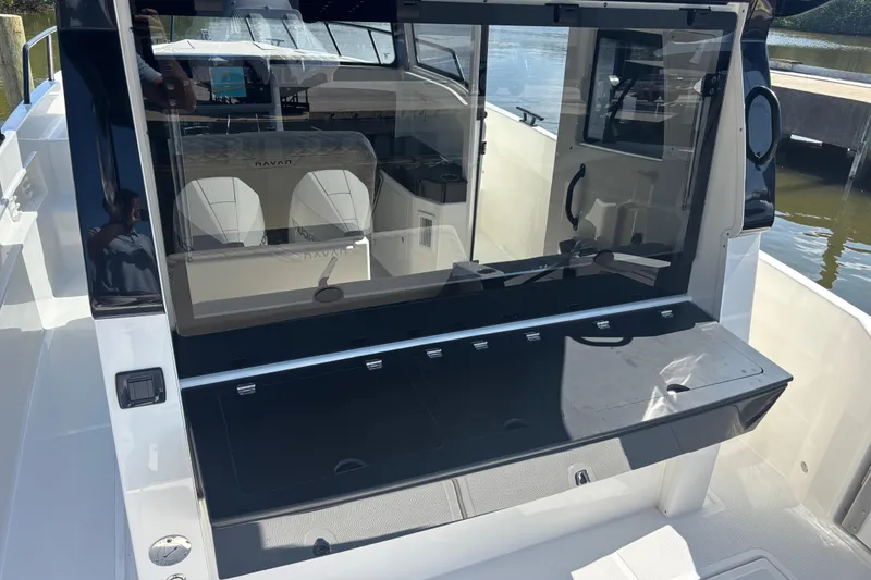Slide: The Image of 2026 Navan C30 boat interior with seating and control panel, docked by the water. - 14